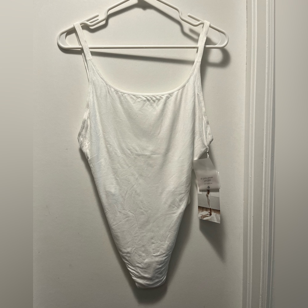 Never worn LuLuLemon Heart Opener Bodysuit in white.